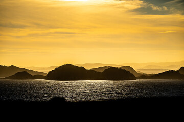 Sea haze in a rocky landscape at sunset.