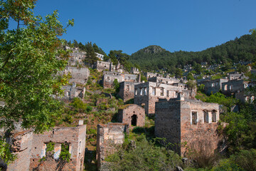 Fototapeta premium Fethiye Kayaköy stone houses and ruins. Mugla, Turkey. Kayakoy ghost village. Turkey's abandoned houses. The Ghost Town of Kayakoy. Abandoned religious ghost city.