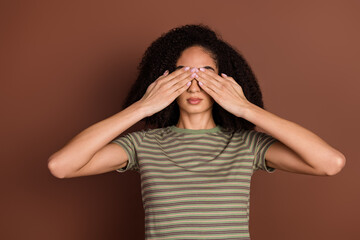 Photo of shy attractive lady dressed striped t-shirt arms close eyes empty space isolated brown color background
