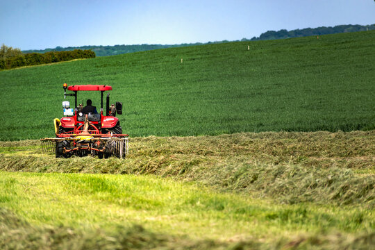 Tractor carrying out work in the field in spring
