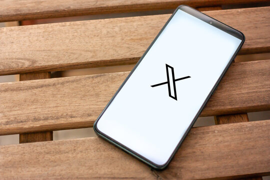 X logo, formerly Twitter, online social media and social networking service owned by Elon Musk, displayed on smartphone screen