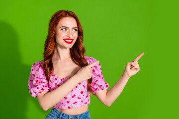 Photo of shiny attractive lady dressed print top showing two fingers empty space isolated green color background