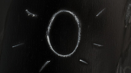 Number 0 hand drawn with chalk on  chalkboard
