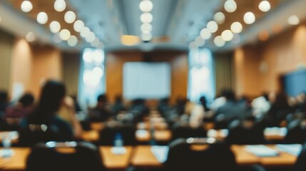 Blurred background of a seminar room filled with attendees listening to a business speech - professional conference setting with people engaged in learning and networking