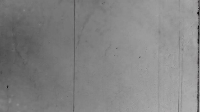 Old black and white scratches noise on film backdrop. Natural, real cinematic loader movie reel. Countdown loader overlay nostalgic wallpaper. Vintage archive transition. Archival retro 1960s texture