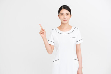 エステティシャン/セラピスト。彼女は指をさし示している。