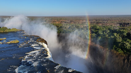 Water Fall Rainbow At Victoria Falls In Matabeleland North Zimbabwe. Nature Waterfall. Zambezi River Landscape. Victoria Falls At Matabeleland North Zimbabwe. Southern Africa. Tourism Travel.