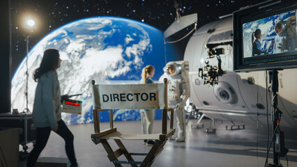 Director Filming Astronaut Scene With Digital Earth Backdrop. Actor in Harness Simulates Spacewalk for Ad Shoot. Behind-the-scenes of Virtual Production.
