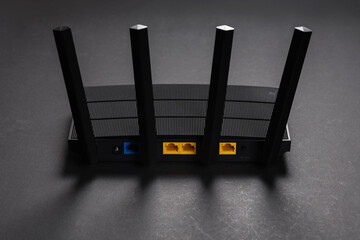 Modern stylish Wi-Fi router on a dark background. Organization of wireless networks