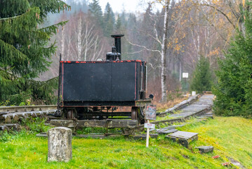 A black locomotive sits on the Sumava Southern Railway tracks, the shortest international railroad in the world, located between Czechia and Germany. Nove Udoli.