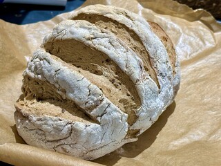 Freshly Baked Artisan Whole Wheat Bread with Crusty Exterior on Parchment Paper