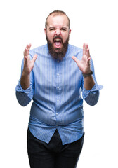 Fototapeta premium Young caucasian hipster man over isolated background crazy and mad shouting and yelling with aggressive expression and arms raised. Frustration concept.