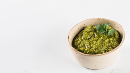 Fresh homemade pesto sauce in a bowl. Italian cuisine. Recipe. Copy space