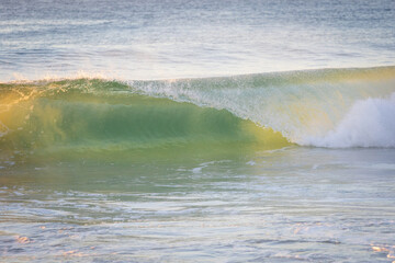 Small wave breaking at the beach.