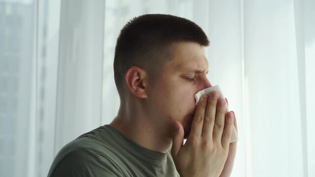 The man had an allergic reaction.
A man blows his nose into a handkerchief.
Seasonal allergies