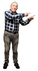 Naklejka premium Handsome senior man wearing casual shirt smiling and looking at the camera pointing with two hands and fingers to the side.