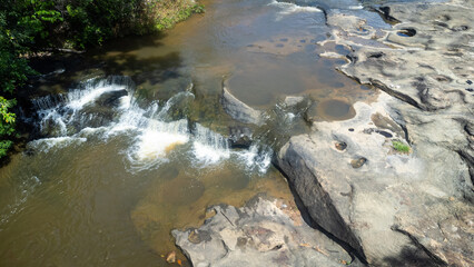 River stream waterfall in forest landscape, beautiful nature water stream with rocks in the tropical forest.Abundant forest.Wangyai waterfall ,Sisaket,Thailand.