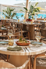 Healthy Mediterranean dishes at an open-air cafe table.