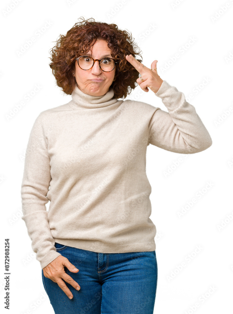 Wall mural Beautiful middle ager senior woman wearing turtleneck sweater and glasses over isolated background Shooting and killing oneself pointing hand and fingers to head, suicide gesture.