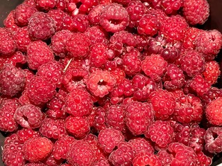 Close-Up of Freshly Picked Raspberries Displaying Their Vibrant Red Color and Juicy Texture