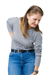 Fototapeta premium Middle age mature beautiful woman wearing stripes winter sweater over isolated background Suffering of backache, touching back with hand, muscular pain