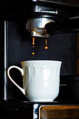 Espresso shot pouring out of an espresso maker.