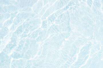 White water with ripples on the surface. Defocus blurred transparent white colored clear calm water surface texture with splashes and bubbles. Water waves with shining pattern texture background.