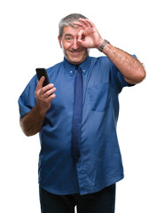 Handsome senior man texting sending message using smartphone over isolated background with happy face smiling doing ok sign with hand on eye looking through fingers