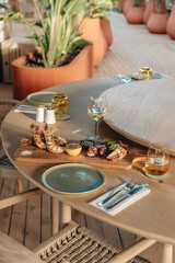 Shrimps grilled, prawns served with lime and sauce on a restaurant table wooden. Seafood.