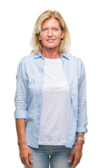 Middle age blonde woman over isolated background with serious expression on face. Simple and natural looking at the camera.