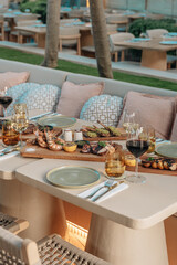 Shrimps grilled, prawns served with lime and sauce on a restaurant table wooden. Seafood.