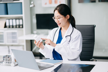 female doctor sitting on work desk Medical online, e health concept. Doctor using laptop for work, video call video chat .