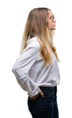 Young beautiful blonde business woman wearing glasses over isolated background looking to side, relax profile pose with natural face with confident smile.