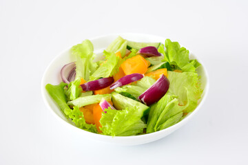 a bowl of salad with red onions and green salad leaves 