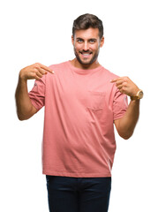 Young handsome man over isolated background looking confident with smile on face, pointing oneself...