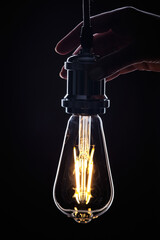 Retro light bulb on black background.
