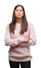 Fototapeta premium Young beautiful hispanic woman wearing a sweater skeptic and nervous, disapproving expression on face with crossed arms. Negative person.