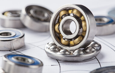 different bearings on blue print background. Part of mechanism.