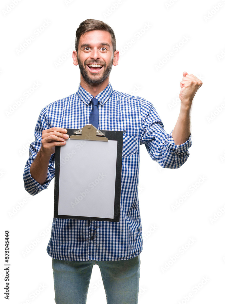 Sticker Young handsome business man holding clipboard over isolated background screaming proud and celebrating victory and success very excited, cheering emotion