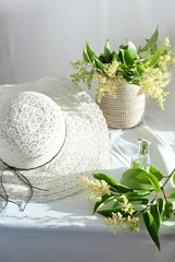 white hat and flowerson a white background 