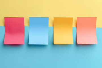Fototapeta premium Four blank sticky notes on blue and yellow background.