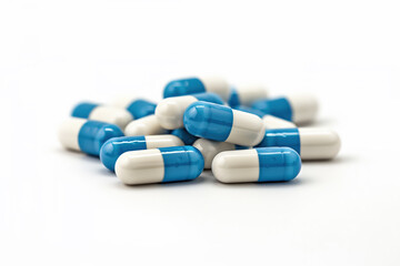 Blue and white pills stacked on an isolated white background.