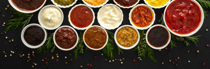 Different types of sauces in bowls with seasonings banner, rosemary and dill, thyme and and peppercorns, top view