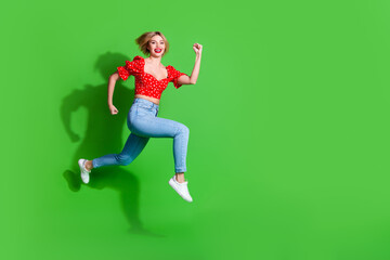Photo of positive girl run profile side jump isolated green color background