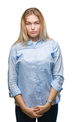 Young caucasian business woman over isolated background with serious expression on face. Simple and natural looking at the camera.