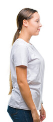 Young beautiful caucasian woman over isolated background looking to side, relax profile pose with...