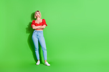 Photo of sad girl with crossed hands look empty space isolated green color background