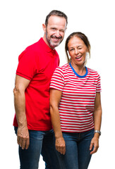 Fototapeta premium Middle age hispanic couple in love over isolated background winking looking at the camera with sexy expression, cheerful and happy face.