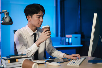 Obraz premium Businessman working at office with laptop and documents on desk, financial adviser analyzing data, employees working overtime.
