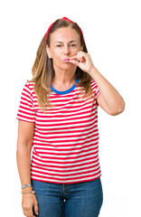 Beautiful middle age woman wearing casual stripes t-shirt over isolated background mouth and lips...